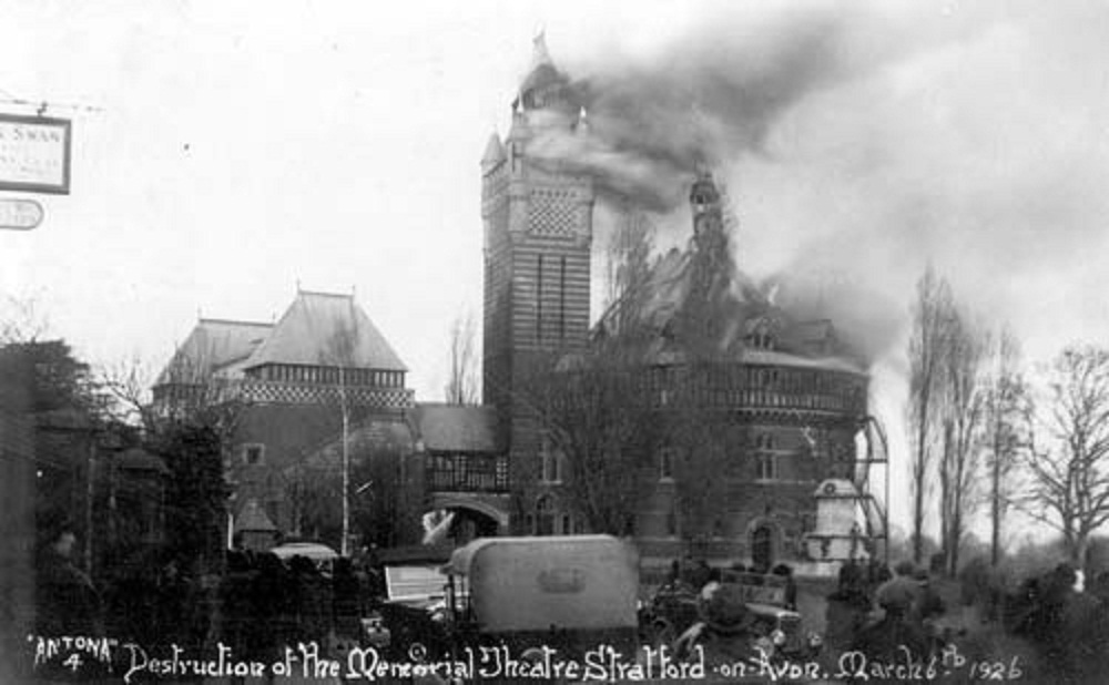 a post card image of the original theatre on fire, in black and white