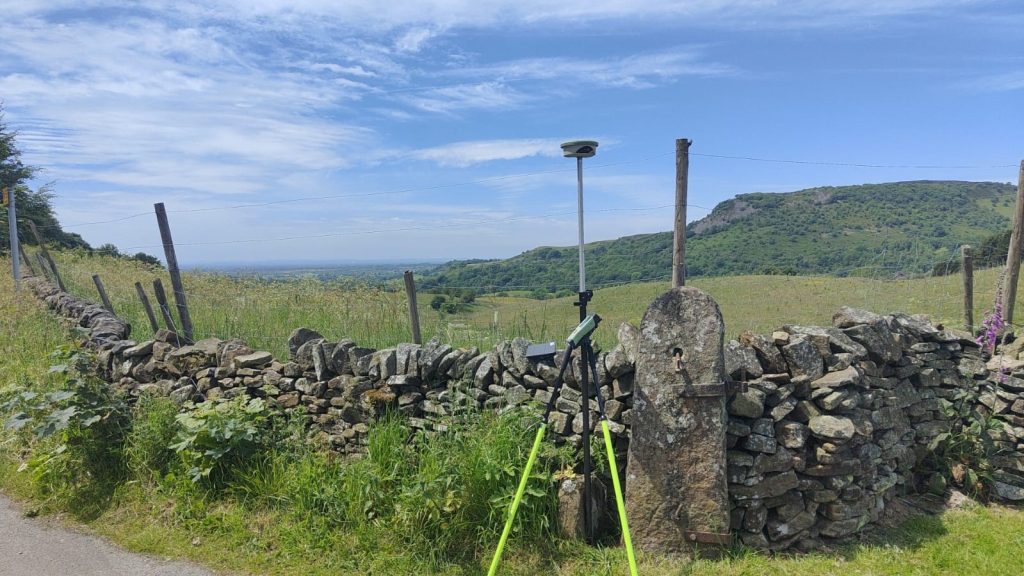 GPS unit next to a stone wall