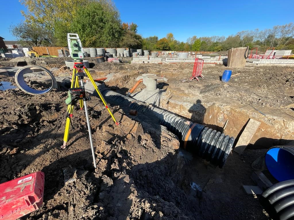 total station on a construction site, lots of mud, for setting out